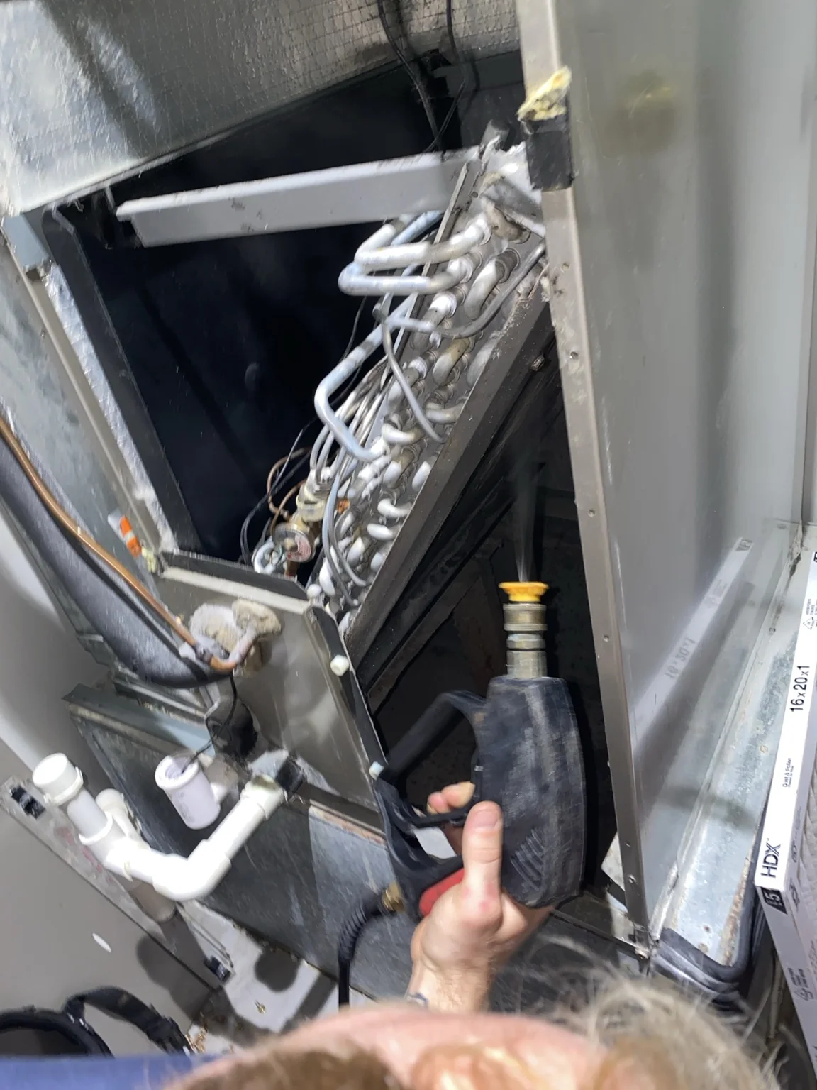 Technician servicing a commercial HVAC coil