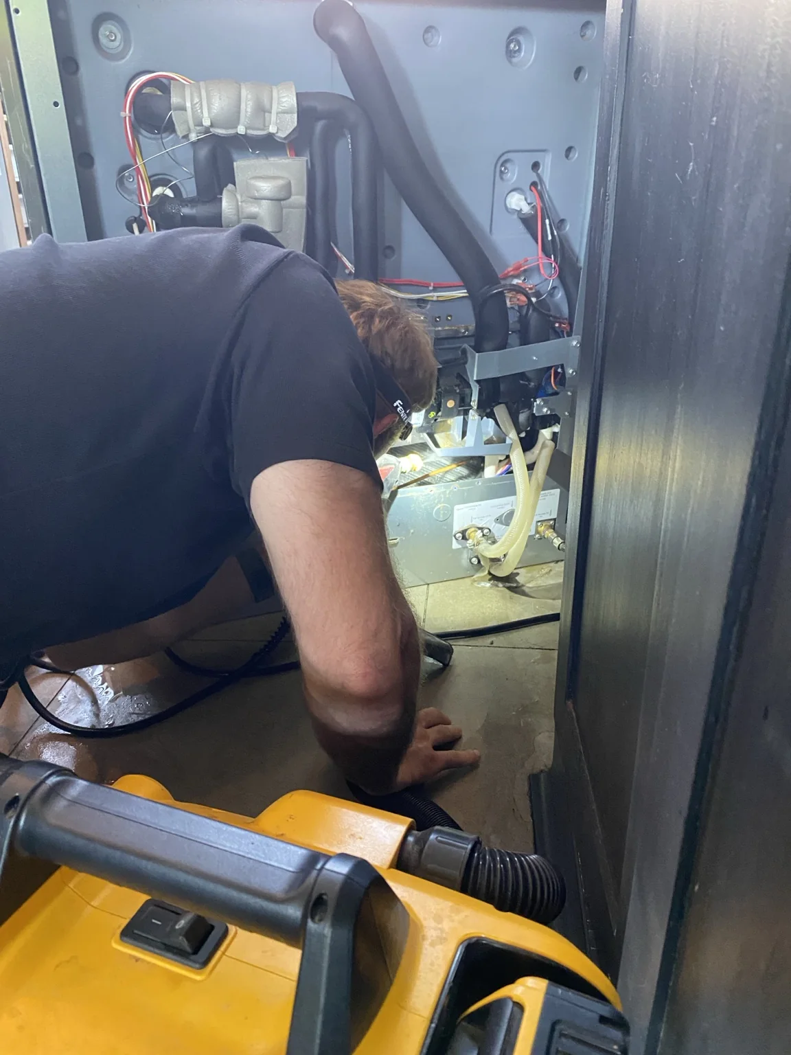 Technician servicing commercial mechanical equipment