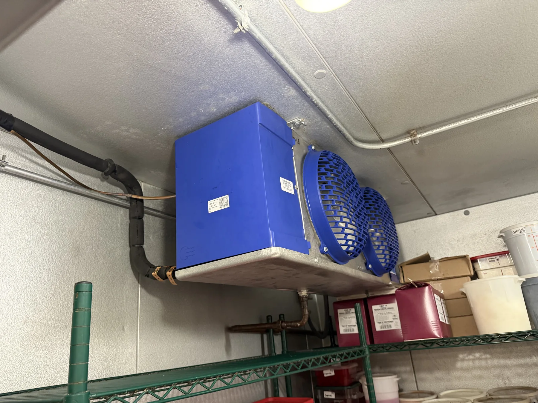 Commercial refrigeration evaporator equipment mounted inside a cooled space